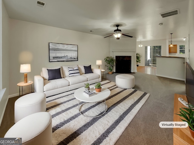 living room with ceiling fan and carpet floors