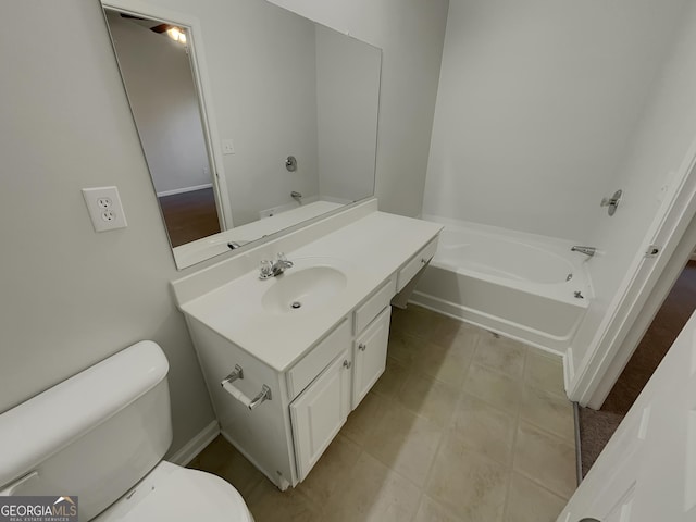 bathroom featuring vanity, a tub, and toilet