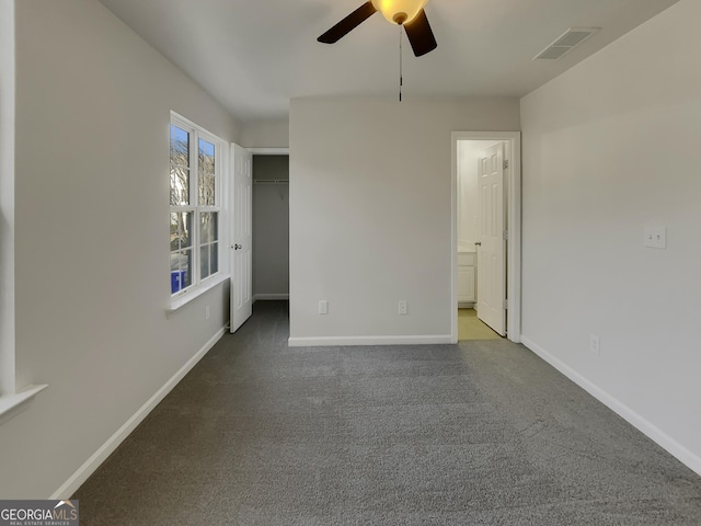 empty room with ceiling fan and carpet flooring