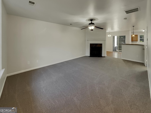 unfurnished living room featuring carpet floors, a high end fireplace, and ceiling fan