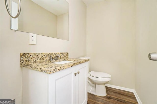 bathroom featuring vanity, toilet, and wood-type flooring