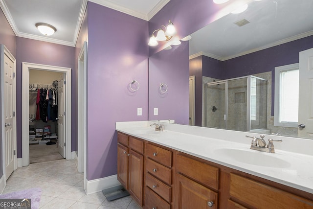 bathroom featuring walk in shower, vanity, crown molding, and tile patterned flooring