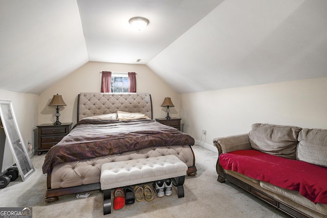 bedroom featuring lofted ceiling and light colored carpet