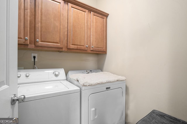 washroom with cabinets and separate washer and dryer