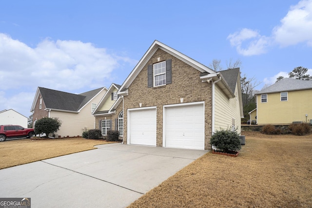 view of front of property with cooling unit, a garage, and a front lawn