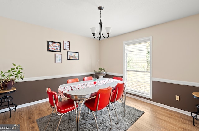 dining room featuring hardwood / wood-style floors and a chandelier