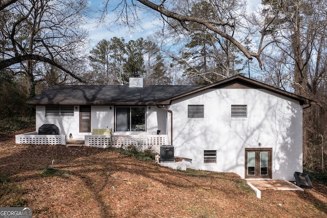 ranch-style house with a patio and cooling unit