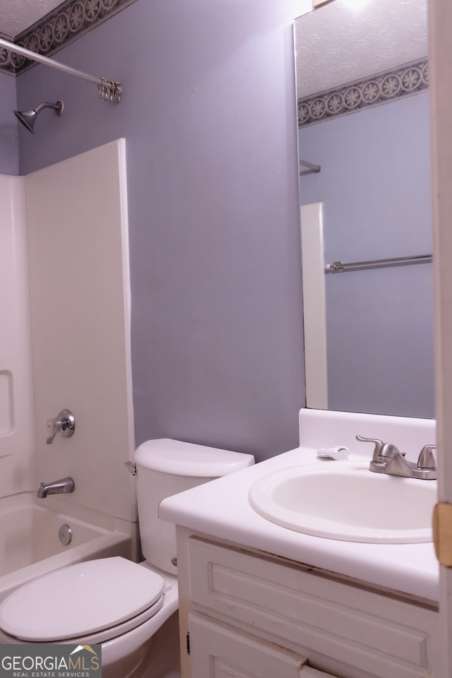 full bathroom with shower / bathtub combination, vanity, and toilet