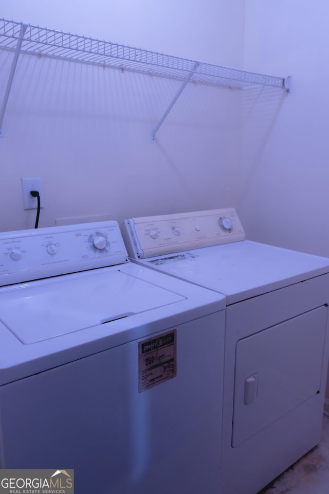 clothes washing area featuring washing machine and clothes dryer