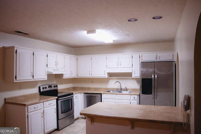 kitchen with white cabinetry, appliances with stainless steel finishes, sink, and a textured ceiling