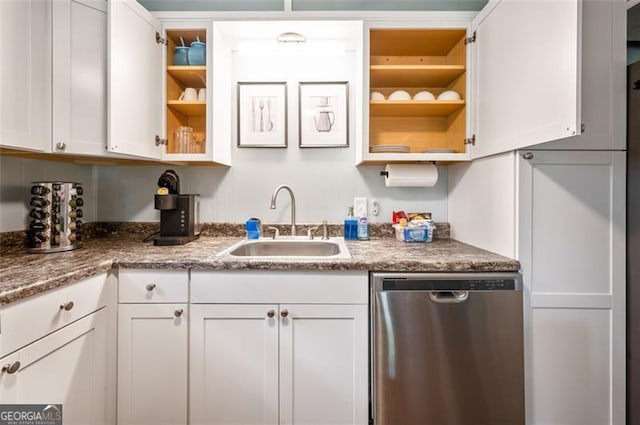 kitchen featuring white cabinets, dark stone counters, sink, and dishwasher