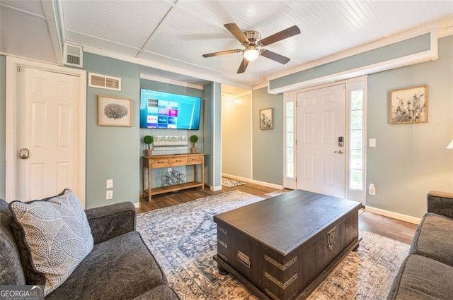 living room with wood-type flooring and ceiling fan