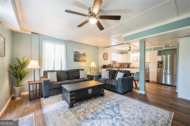 living room with dark hardwood / wood-style floors and ceiling fan