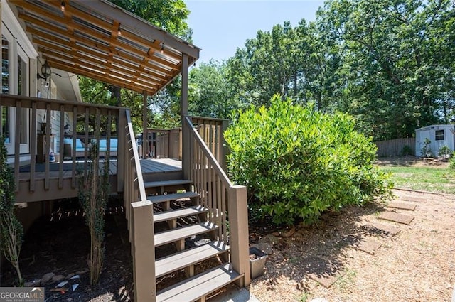 view of yard with a deck and a storage unit