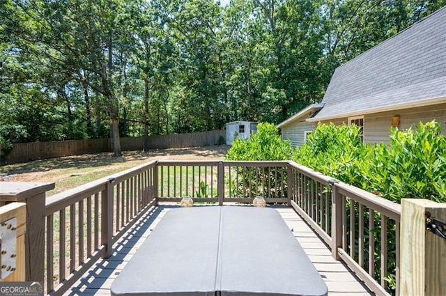 wooden terrace with a storage shed