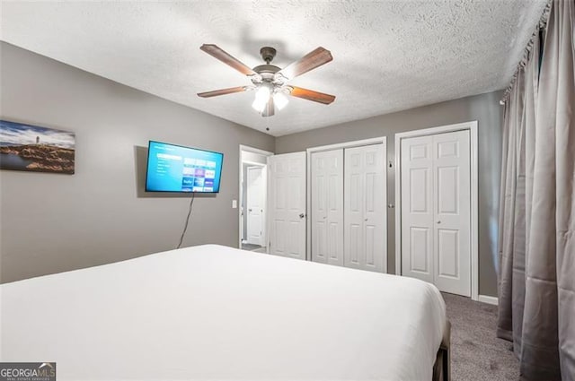 4297 Earney Rd, Woodstock, GA 30188 - bedroom featuring carpet floors, multiple closets, ceiling fan, and a textured ceiling