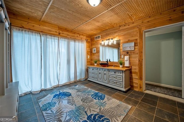 bathroom featuring tile patterned floors, vanity, wooden walls, and wooden ceiling