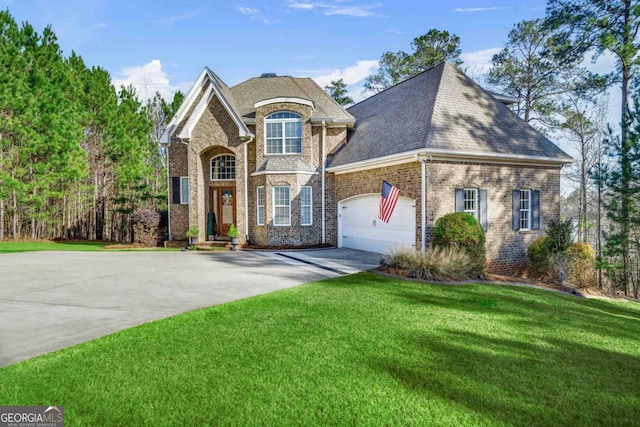 view of front of home with a garage and a front yard