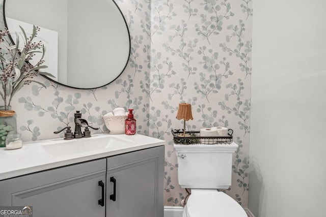 bathroom featuring vanity and toilet