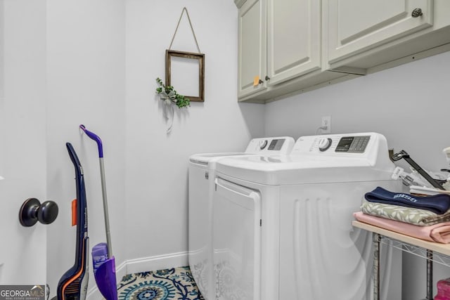 laundry room with cabinets and washer and dryer