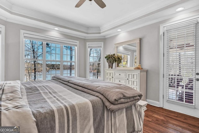 bedroom with crown molding, access to outside, dark hardwood / wood-style flooring, a raised ceiling, and ceiling fan