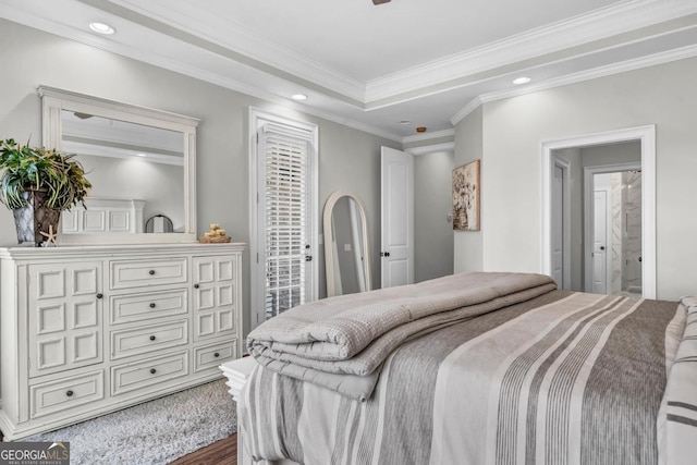 bedroom featuring ensuite bathroom, ornamental molding, dark hardwood / wood-style flooring, a raised ceiling, and access to exterior