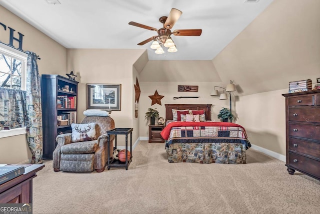 bedroom featuring light carpet, vaulted ceiling, and ceiling fan