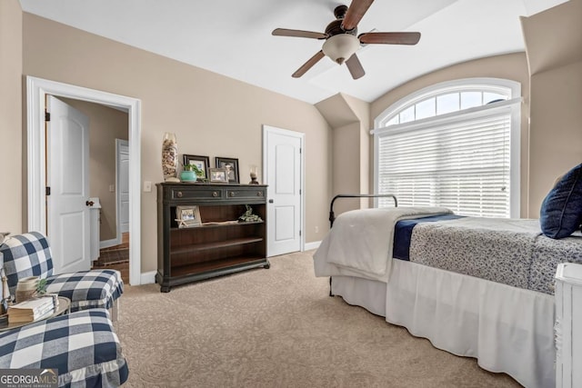 carpeted bedroom featuring lofted ceiling, radiator, and ceiling fan