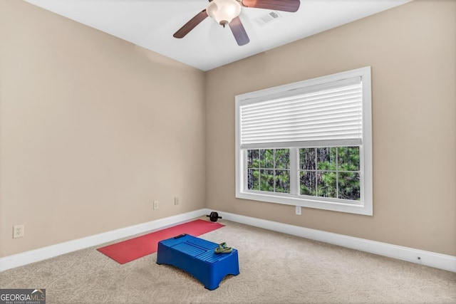 spare room featuring ceiling fan and carpet flooring