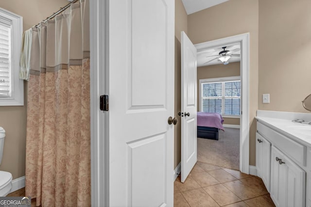 bathroom featuring ceiling fan, tile patterned floors, toilet, and vanity