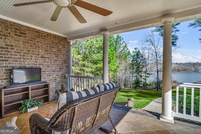 view of patio / terrace featuring a water view and ceiling fan