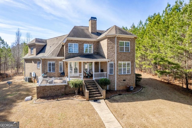 view of front of property featuring covered porch and central air condition unit