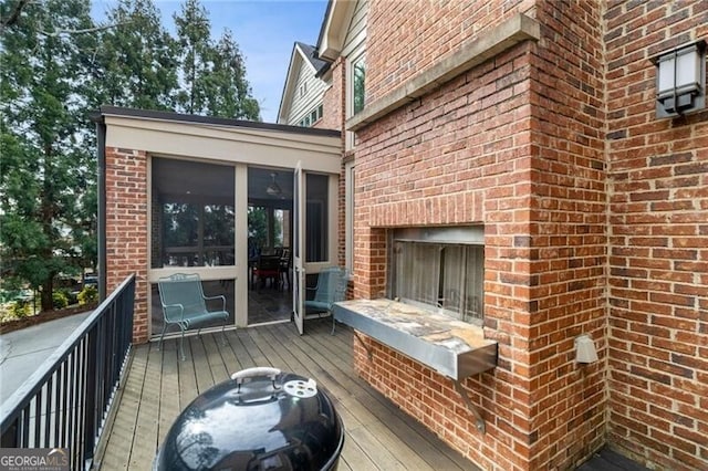 wooden terrace featuring a sunroom