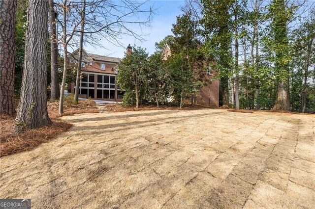 view of yard featuring a sunroom