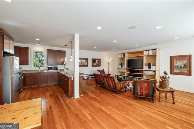 living room featuring sink and light hardwood / wood-style floors