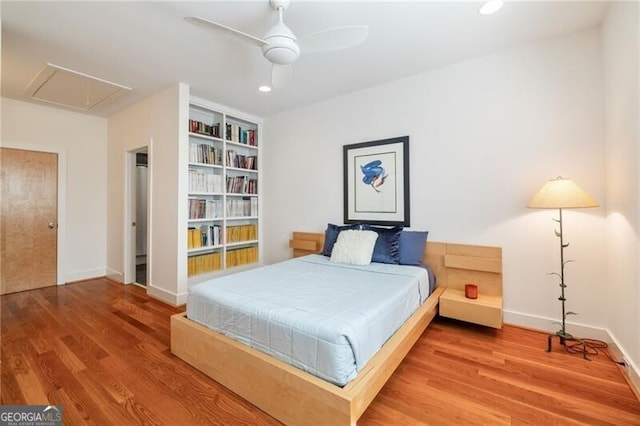 bedroom with hardwood / wood-style floors and ceiling fan