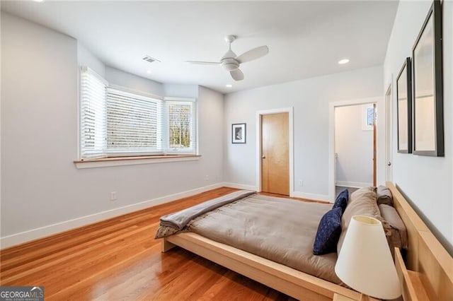 bedroom with hardwood / wood-style floors and ceiling fan