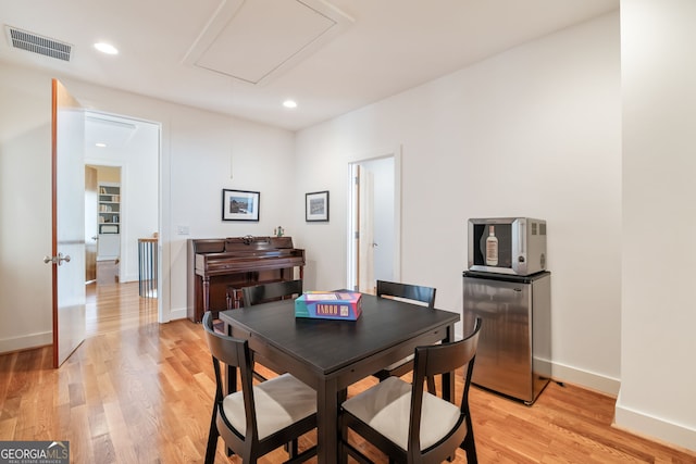 dining space with light wood-type flooring