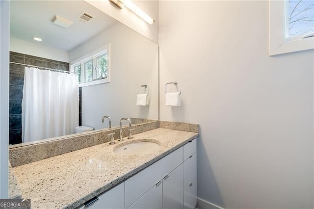 bathroom featuring vanity and curtained shower