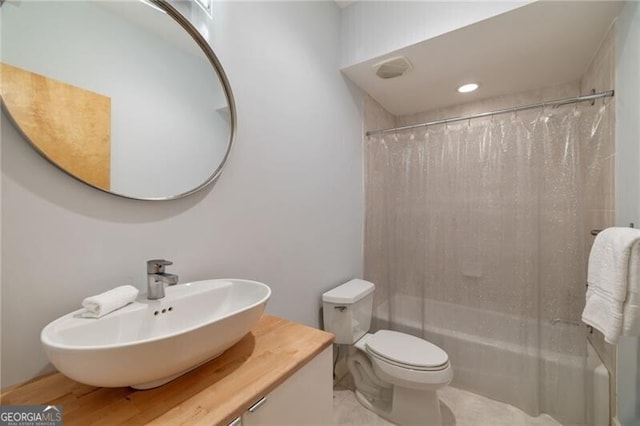 full bathroom featuring shower / bath combination with curtain, vanity, and toilet