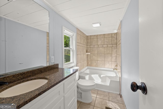 full bathroom with tile patterned flooring, vanity, tiled shower / bath, and toilet