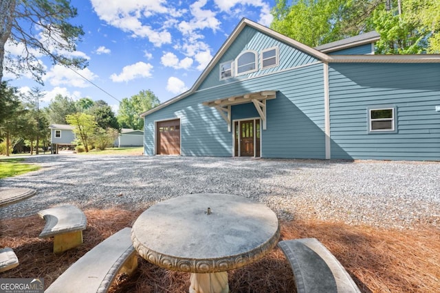 rear view of property featuring a garage