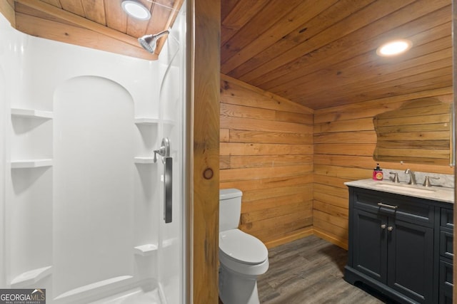 bathroom with toilet, wood walls, wood-type flooring, wooden ceiling, and vanity