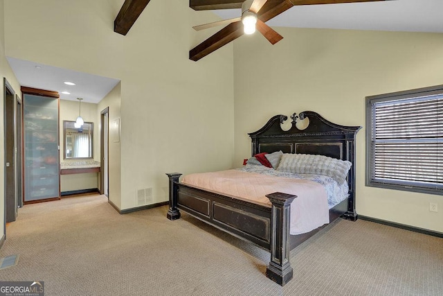 carpeted bedroom featuring beam ceiling, ceiling fan, ensuite bathroom, and high vaulted ceiling