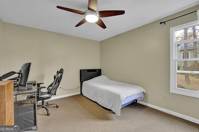 bedroom featuring ceiling fan and carpet