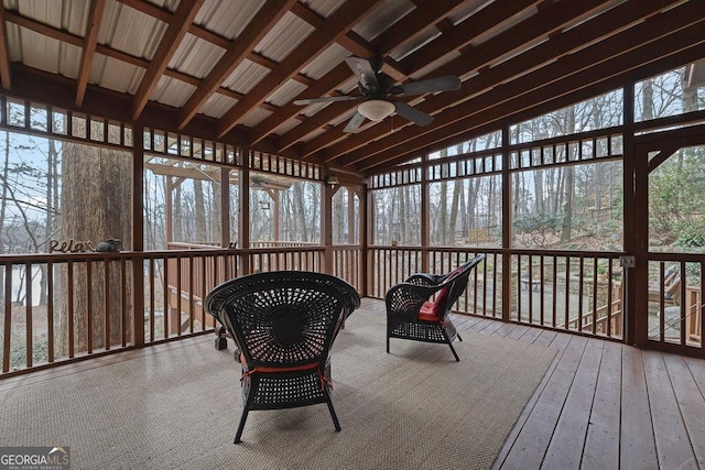 sunroom featuring lofted ceiling and ceiling fan