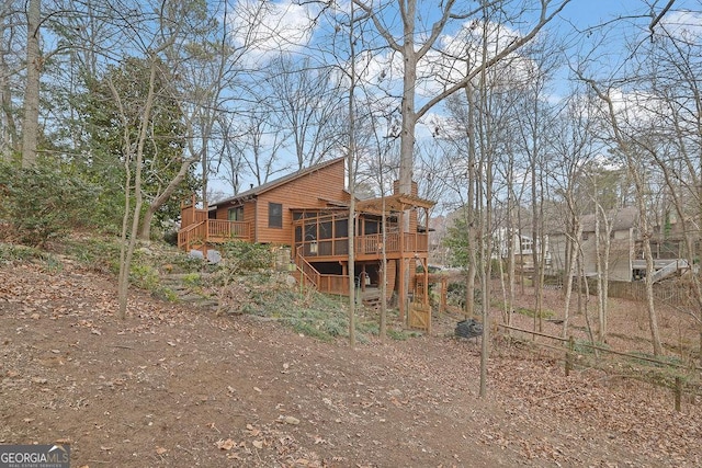 back of house with a wooden deck