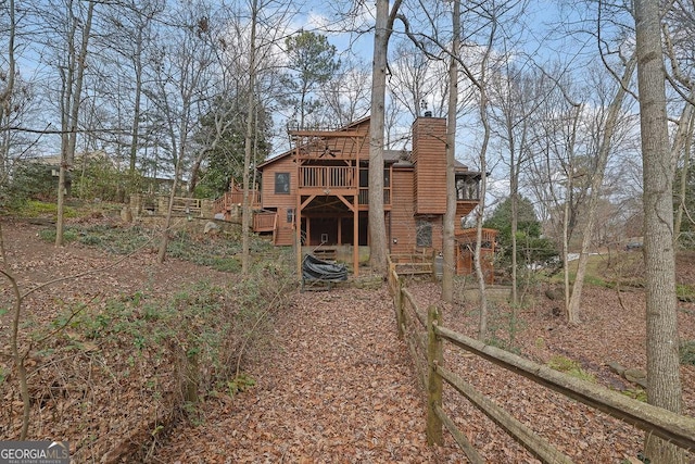 back of property featuring a wooden deck