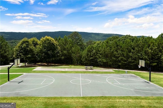 view of sport court featuring a lawn