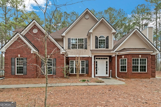 traditional-style house with brick siding and roof with shingles